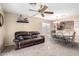 Inviting living area featuring neutral tones, ceiling fan, and open access to the dining area at 45 S 238Th Dr, Buckeye, AZ 85396