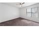 Bright bedroom featuring a ceiling fan, carpeted floor, and a window with natural light at 461 W Holmes -- # 342, Mesa, AZ 85210