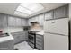 Well-lit kitchen featuring grey cabinets, white countertops, stainless steel appliances, and a skylight at 461 W Holmes -- # 342, Mesa, AZ 85210