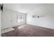 This vacant living room has tan carpet, white walls, and a front door leading to the exterior at 461 W Holmes -- # 342, Mesa, AZ 85210