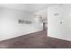 A vacant living room with white walls, tan carpet, and a ceiling fan. Has a minimalist design at 461 W Holmes -- # 342, Mesa, AZ 85210