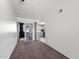 Bright living room with vaulted ceiling, sliding glass doors to the porch, and view of adjacent kitchen at 461 W Holmes -- # 342, Mesa, AZ 85210