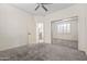 Bedroom with mirrored closet doors offers plush carpet, neutral walls, and a glimpse of the staircase at 4630 E Carriage Ct, Gilbert, AZ 85297