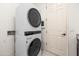 Modern laundry room features a stacked washer and dryer with a convenient door nearby at 4630 E Carriage Ct, Gilbert, AZ 85297