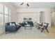 Open-concept living room with modern sofas, a glass coffee table, and bright natural light at 4630 E Carriage Ct, Gilbert, AZ 85297