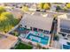 Expansive aerial view of the home, yard, pool, hot tub, outdoor seating, and solar panels at 4637 E Fernwood Ct, Cave Creek, AZ 85331