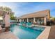 Amazing pool and patio area with pergola, outdoor seating, and a lush green yard at 4637 E Fernwood Ct, Cave Creek, AZ 85331