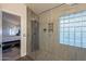 Walk-in shower featuring glass block window and mosaic tile accent at 4637 E Fernwood Ct, Cave Creek, AZ 85331
