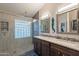Bathroom with walk-in shower, glass block window, double sinks, and decorative mirrors at 4637 E Fernwood Ct, Cave Creek, AZ 85331