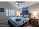 Bedroom with wood-style floor, queen bed, plantation shutters, and ensuite bath at 4637 E Fernwood Ct, Cave Creek, AZ 85331