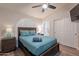 Bedroom with wood-style floor, queen bed, plantation shutters, and ensuite bath at 4637 E Fernwood Ct, Cave Creek, AZ 85331