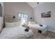 Light and airy bedroom with vaulted ceiling, two beds, and a window with plantation shutters at 4637 E Fernwood Ct, Cave Creek, AZ 85331