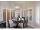 Dining area with wood table, four chairs, modern lighting, and natural light at 4637 E Fernwood Ct, Cave Creek, AZ 85331