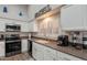 Bright kitchen features white cabinets, stainless steel appliances, and a window with plantation shutters at 4637 E Fernwood Ct, Cave Creek, AZ 85331