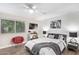 Comfortable bedroom featuring a ceiling fan, modern decor, and natural light from the window at 4709 N 77Th Pl, Scottsdale, AZ 85251