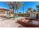 Landscaped backyard with a pool, spa, artificial grass, mature trees, and storage shed at 4791 S White Pl, Chandler, AZ 85249