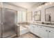 Bathroom featuring a glass-enclosed shower, soaking tub, double vanity, and neutral finishes at 4791 S White Pl, Chandler, AZ 85249