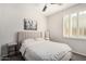 Bedroom with neutral decor, shuttered windows, and whimsical donkey art for a cozy, inviting space at 4791 S White Pl, Chandler, AZ 85249