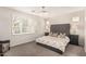 Serene bedroom with tufted headboard, neutral bedding, elegant chandelier, and plantation shutters for natural light at 4791 S White Pl, Chandler, AZ 85249