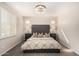 Bedroom with tufted headboard, neutral bedding, elegant chandelier, and plantation shutters for natural light at 4791 S White Pl, Chandler, AZ 85249