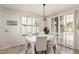 Dining area with large windows and a modern light fixture at 4791 S White Pl, Chandler, AZ 85249