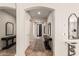 Bright foyer featuring tile floors, a decorative table, and mirrors at 4791 S White Pl, Chandler, AZ 85249