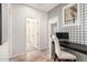 Hallway with designer wallpaper leading to a home office nook with a sleek desk and chair at 4791 S White Pl, Chandler, AZ 85249