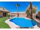 Backyard pool is surrounded by a manicured lawn with desert landscaping and string lighting overhead at 4791 S White Pl, Chandler, AZ 85249