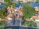 Lakefront property with mature trees, lush landscaping, and a well-maintained yard at 517 S Marina Dr, Gilbert, AZ 85233