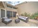 Relaxing back patio with comfortable seating and an outdoor fireplace, ideal for cozy evenings at 517 S Marina Dr, Gilbert, AZ 85233