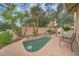 Backyard with a small pool, water feature, mature landscaping, and cozy fireplace at 517 S Marina Dr, Gilbert, AZ 85233