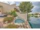Landscaped backyard pool with a rock waterfall feature and lake views, creating a tranquil retreat at 517 S Marina Dr, Gilbert, AZ 85233