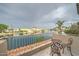 Charming balcony with seating overlooking a tranquil waterfront and waterfront community at 517 S Marina Dr, Gilbert, AZ 85233
