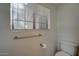 Clean bathroom featuring a standard toilet, towel bar, and a window providing natural light at 517 S Marina Dr, Gilbert, AZ 85233