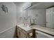 Bathroom with neutral-toned vanity, decorative mirror, and white fixtures at 517 S Marina Dr, Gilbert, AZ 85233