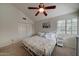 Cozy bedroom with a ceiling fan, plush carpeting, and a comfortable bed near a window at 517 S Marina Dr, Gilbert, AZ 85233