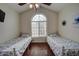 Bright bedroom featuring two twin beds, vaulted ceilings and a large window at 517 S Marina Dr, Gilbert, AZ 85233