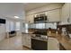 Updated kitchen with stainless steel appliances and a view to an adjacent dining area at 517 S Marina Dr, Gilbert, AZ 85233