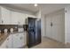 Bright kitchen featuring white cabinets, dark appliances and a tiled floor at 517 S Marina Dr, Gilbert, AZ 85233