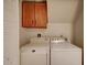 Functional laundry area with washer, dryer, and overhead cabinet storage at 517 S Marina Dr, Gilbert, AZ 85233