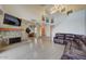 Open-concept living room featuring stone fireplace and staircase at 517 S Marina Dr, Gilbert, AZ 85233
