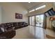 Bright living room with fireplace, large windows, and access to the outdoor patio at 517 S Marina Dr, Gilbert, AZ 85233