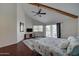 Spacious main bedroom showcasing a beamed vaulted ceiling, ceiling fan and access to the balcony at 517 S Marina Dr, Gilbert, AZ 85233