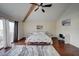 Primary bedroom features a vaulted ceiling, ceiling fan, and a private balcony access at 517 S Marina Dr, Gilbert, AZ 85233