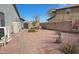 Backyard with gravel landscaping, artificial turf patch, small fruit tree, and perimeter wall at 522 S 122Nd Ln, Avondale, AZ 85323