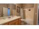 Well-lit bathroom featuring a wood vanity, a framed mirror, and a shower/tub combo with neutral accents at 522 S 122Nd Ln, Avondale, AZ 85323