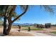 Scenic golf course view featuring lush green fairways against a backdrop of majestic mountains and clear blue sky at 522 S 122Nd Ln, Avondale, AZ 85323
