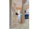 Open hallway showcasing neutral tones, tile flooring, and an archway, connecting to the kitchen and living areas at 522 S 122Nd Ln, Avondale, AZ 85323