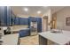 Bright kitchen featuring stainless steel appliances, sleek countertops, and well-crafted blue cabinetry at 522 S 122Nd Ln, Avondale, AZ 85323