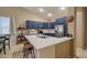 Bright kitchen with stainless steel appliances, stylish blue cabinets, and barstool seating at the island at 522 S 122Nd Ln, Avondale, AZ 85323